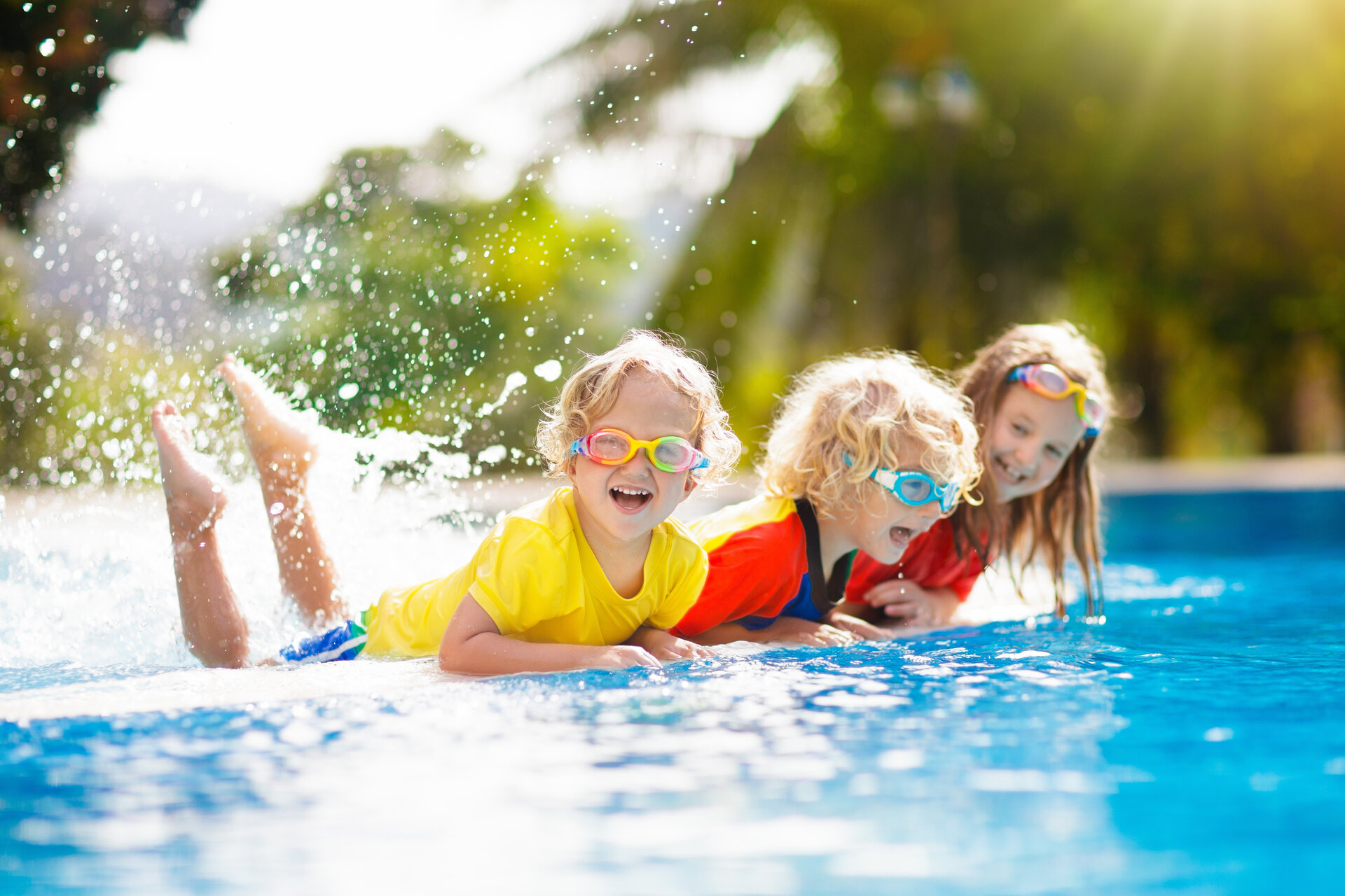 Kinder spielen mit der Familie im Außenpool